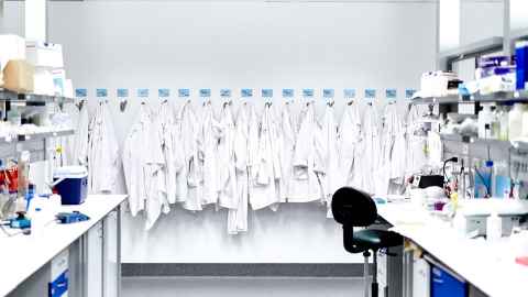 Lab coats lined up on hooks in the Liggins Institute laboratory